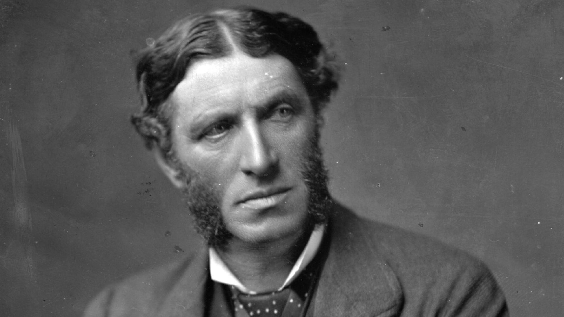 Black-and-white portrait of English poet Matthew Arnold in formal Victorian attire