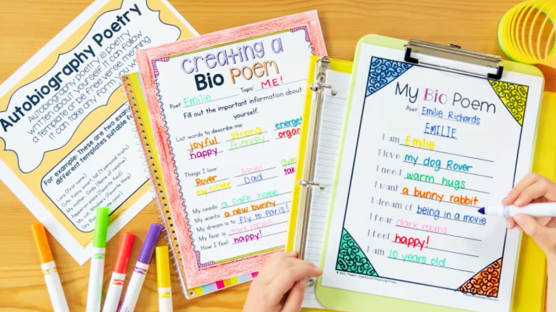 Colorful bio poem worksheets with markers on wooden desk. Student templates for autobiography poetry showing name, traits, loves, and dreams.