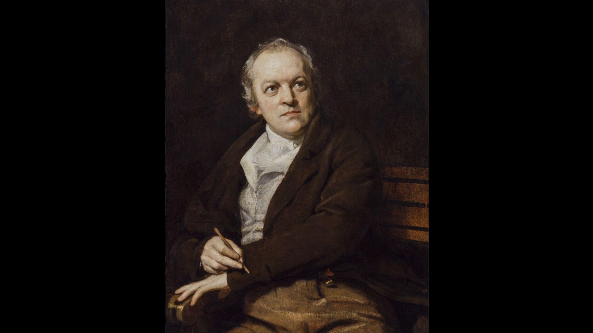 Portrait of William Blake holding a pen while seated.