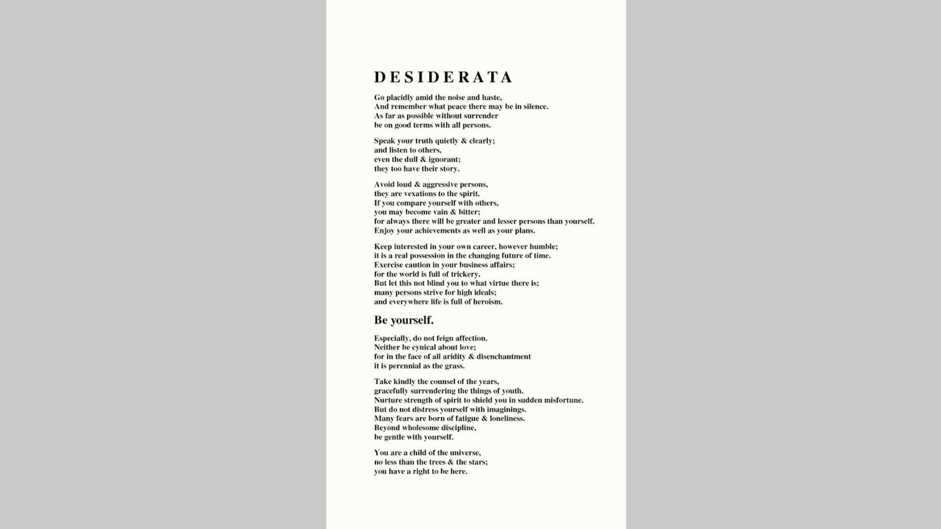 Framed Spanish version of “Desiderata” hanging on a light wall, with text starting “Camina plácidamente entre el ruido y la prisa”.