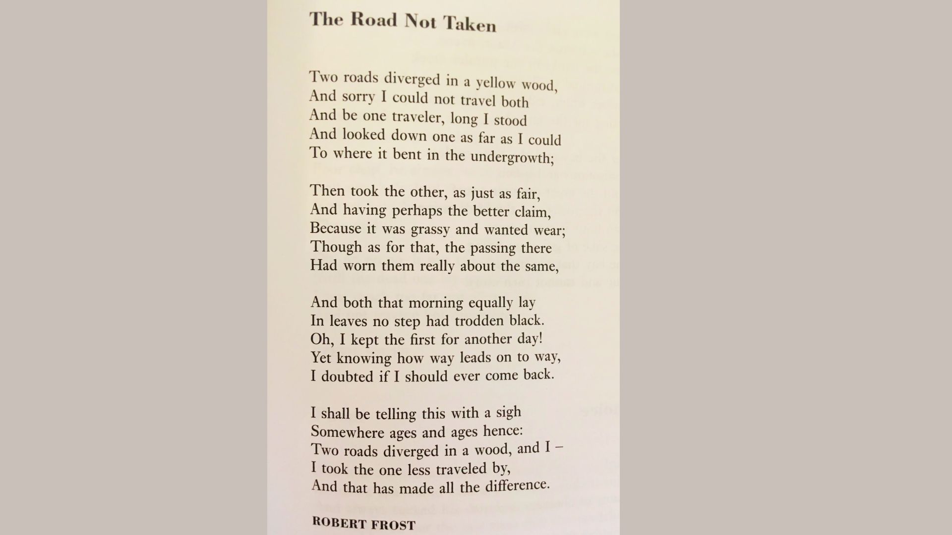 Excerpt of Robert Frost’s poem “The Road Not Taken” printed in black serif font on a white background.