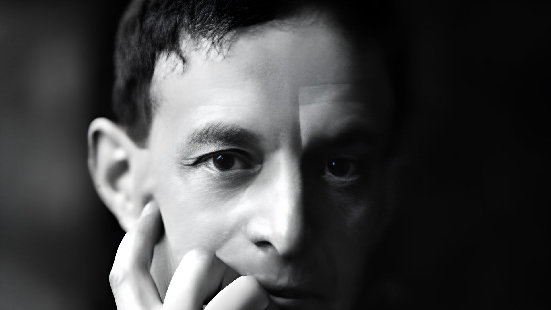 A man in black and white, face half-lit, is the poetWalter de la Mare from“The Listeners.