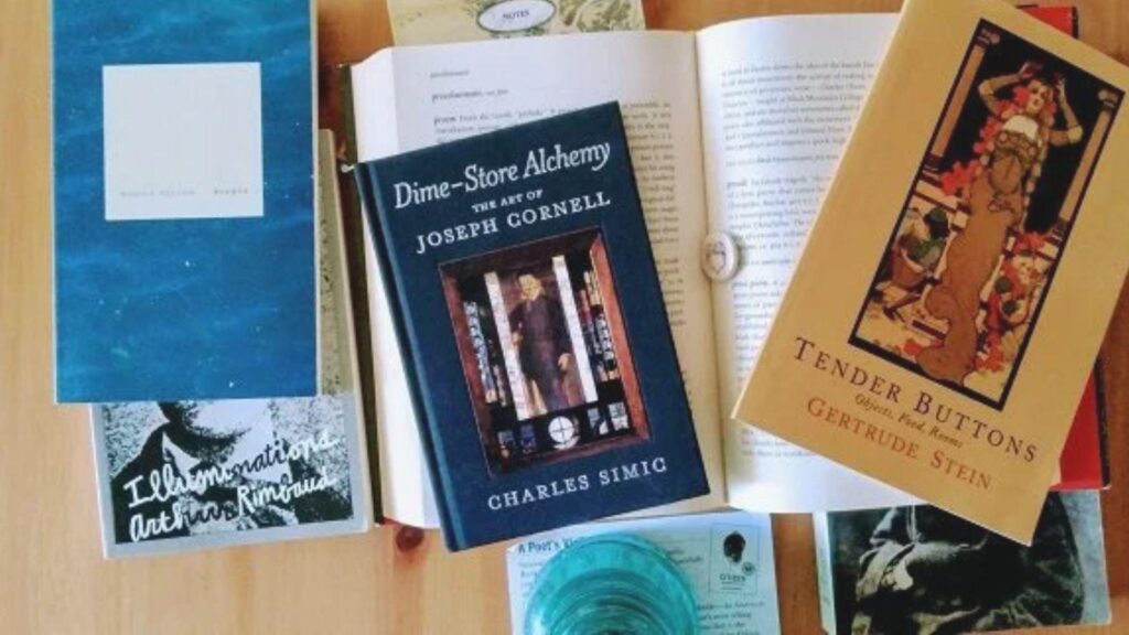 Several books and literary publications arranged on a wooden table
