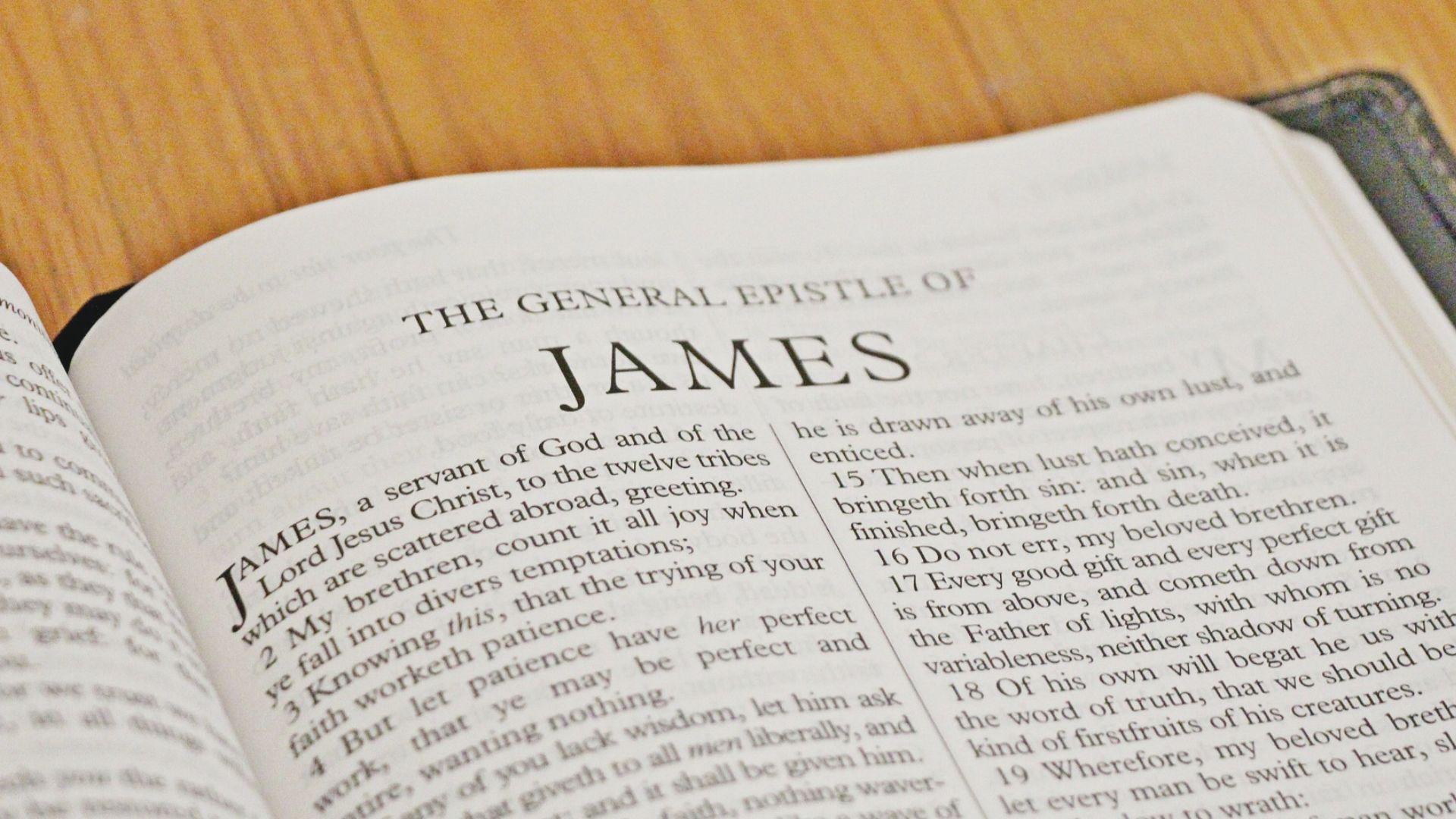 Open book displaying the General Epistle of James on a wooden surface.File Name: general-epistle-of-james-book