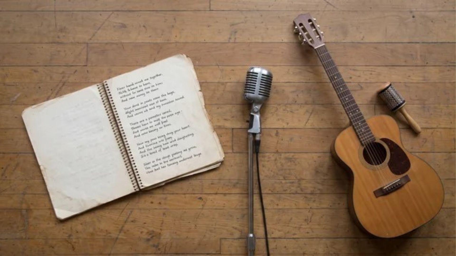 Poem script, microphone, and musical instrument arranged on a stage surface