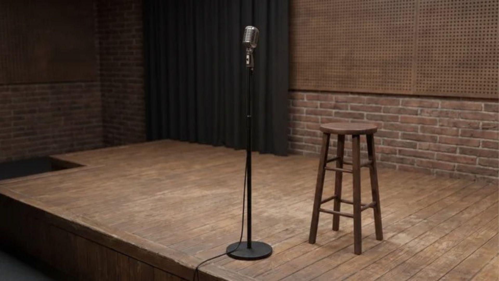 Microphone and empty wooden stool on a small poetry stage