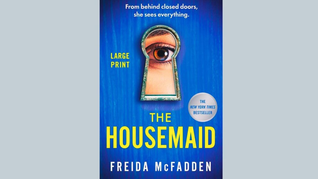 Book cover of The Housemaid by Freida McFadden featuring an eye-shaped keyhole.