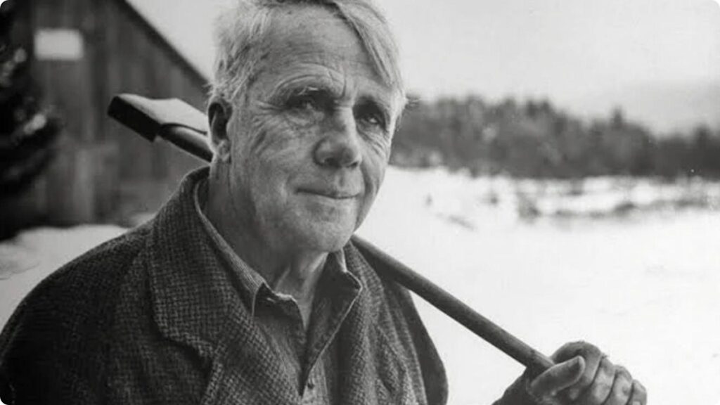 Black and white portrait of Robert Frost carrying an axe over shoulder. File Name:portrait-robert-frost