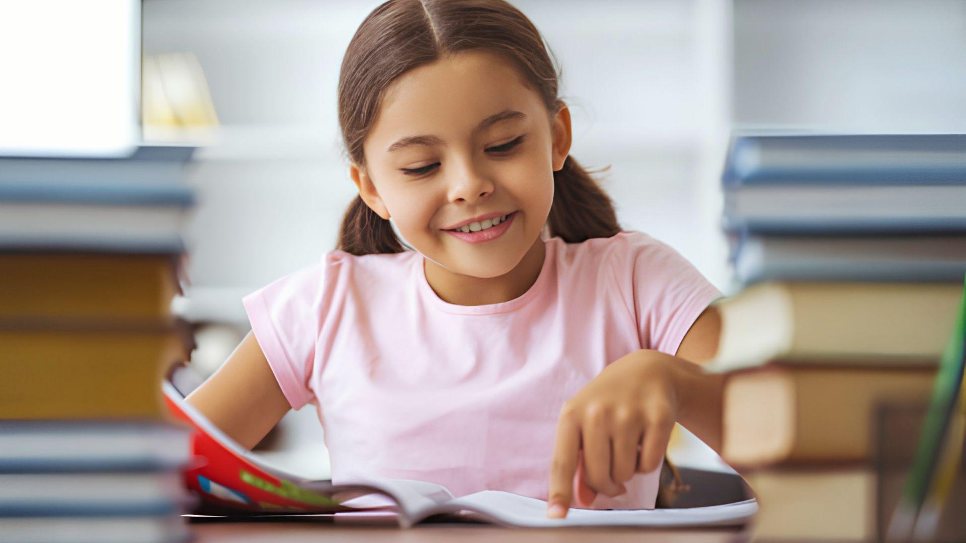 A girl reading a tongue twister from a book. File Name: kids reading alliteration aloud