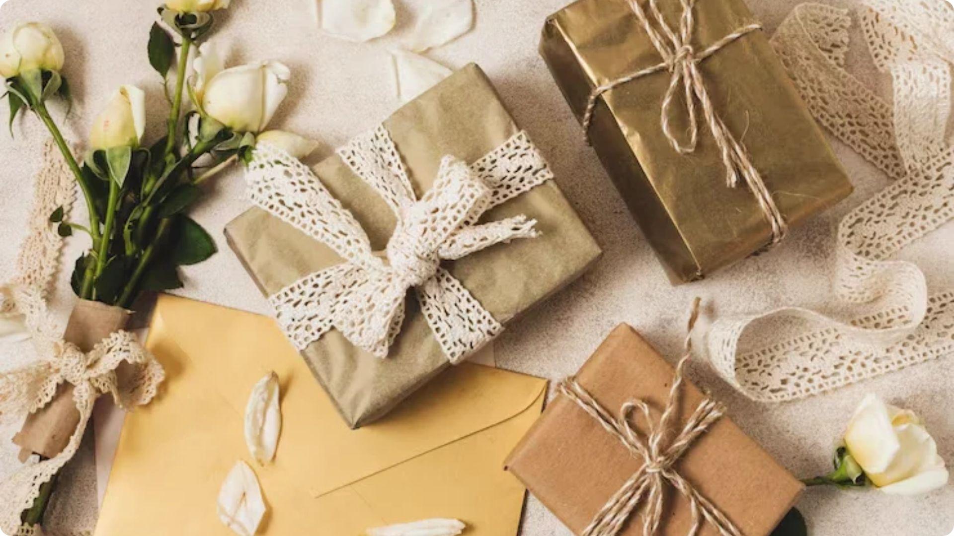 Three gift boxes wrapped in gold paper with lace bows and twine.File name: about-ode-to-my-socks