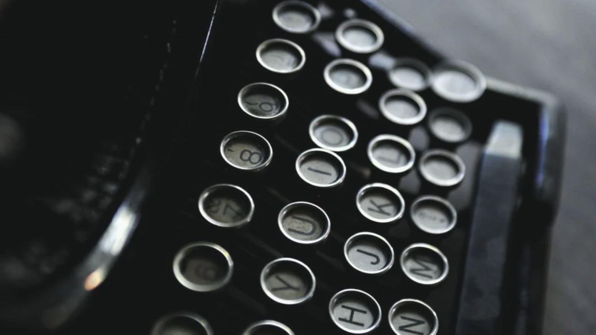 Close-up of vintage black typewriter keys from above File Name: vintage-black-typewriter-keys-close-up-poetry-writing