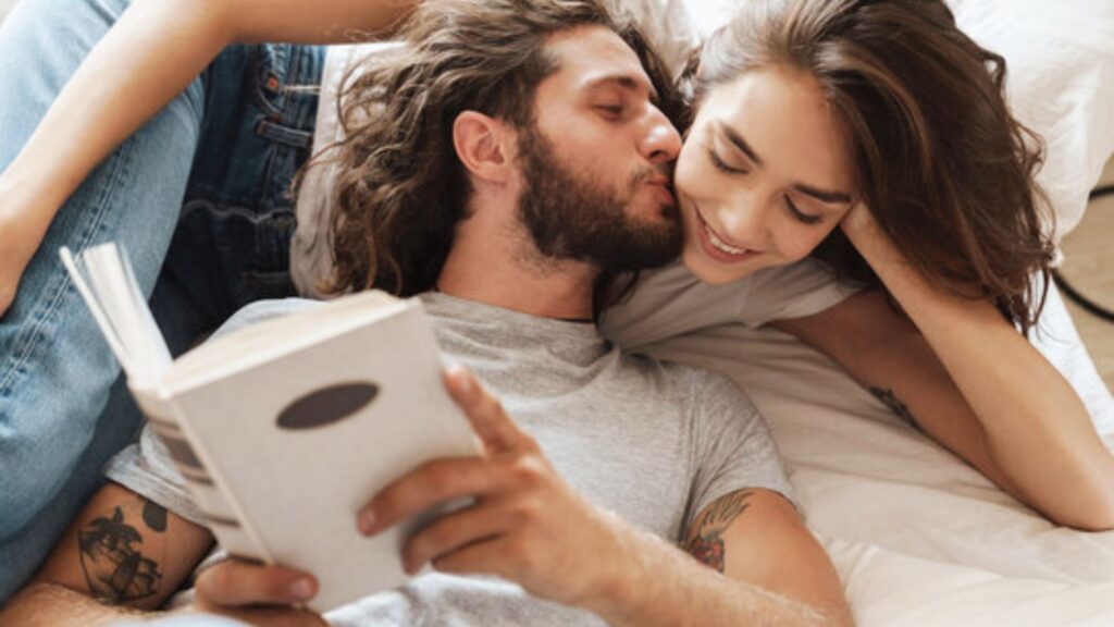 Couple cuddled close, reading a love poem together, sharing a quiet moment.